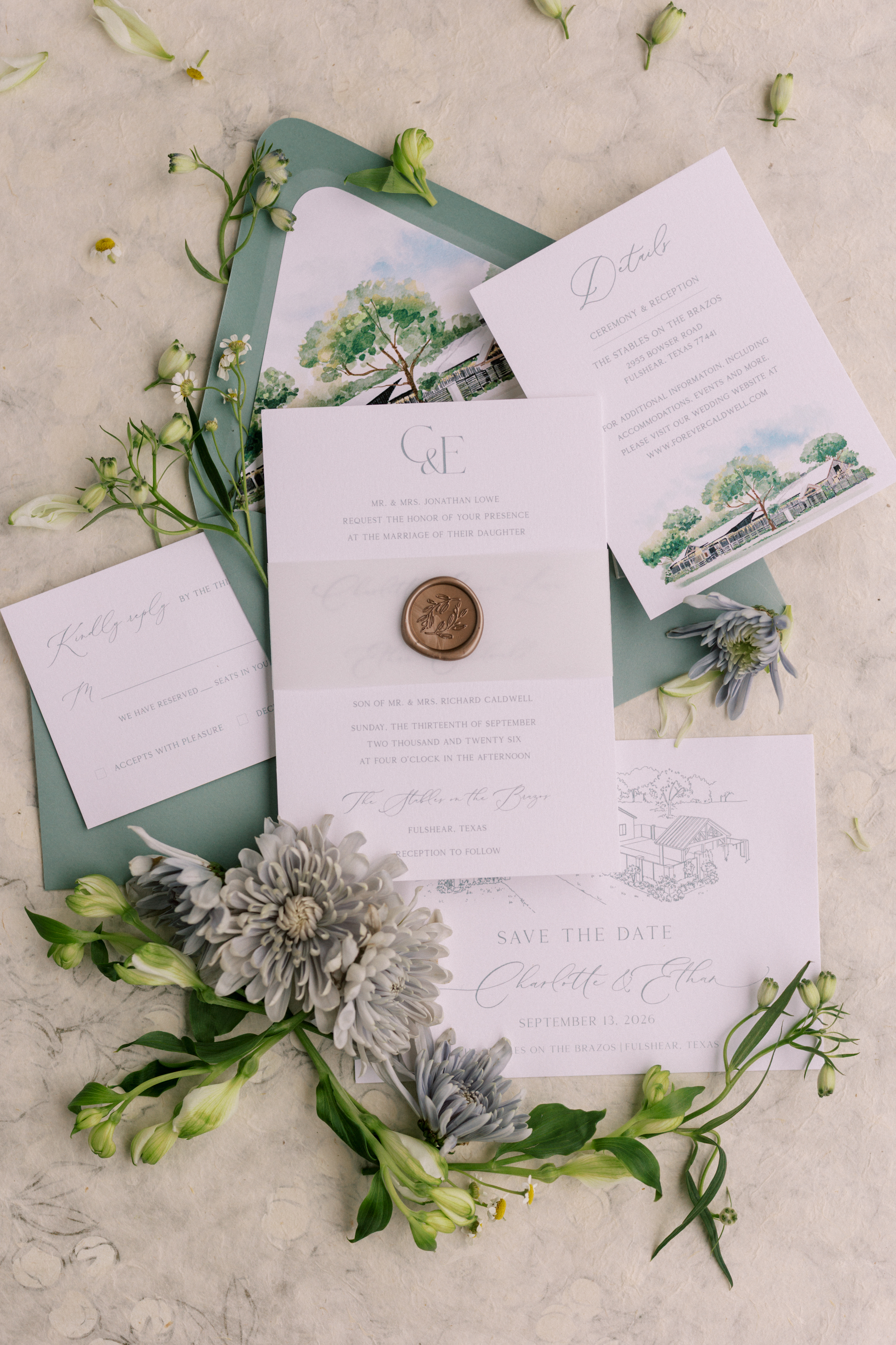 Flat lay of a sage green and white wedding stationery suite with watercolor and line-art venue illustrations, a wax seal, and blue-grey flowers